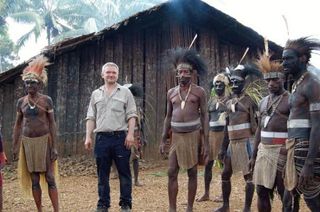 Gibbon with members of the Biami tribe, wearing traditional garb. The tribe wore the same dress for a song celebration several nights later.