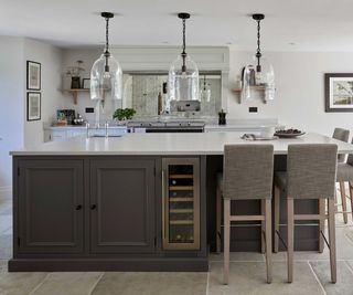 large grey kitchen island with white worktops and wine cooler