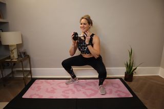 LDN Mum's Fitness founder Sarah Campus demonstrating a dumbbell squat