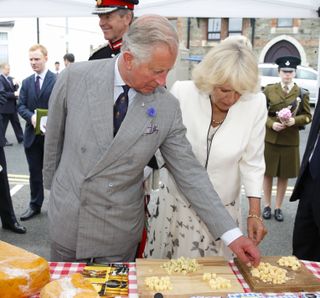 Prince Charles, Prince of Wales and Camilla, Duchess of Cornwall sample some cheese