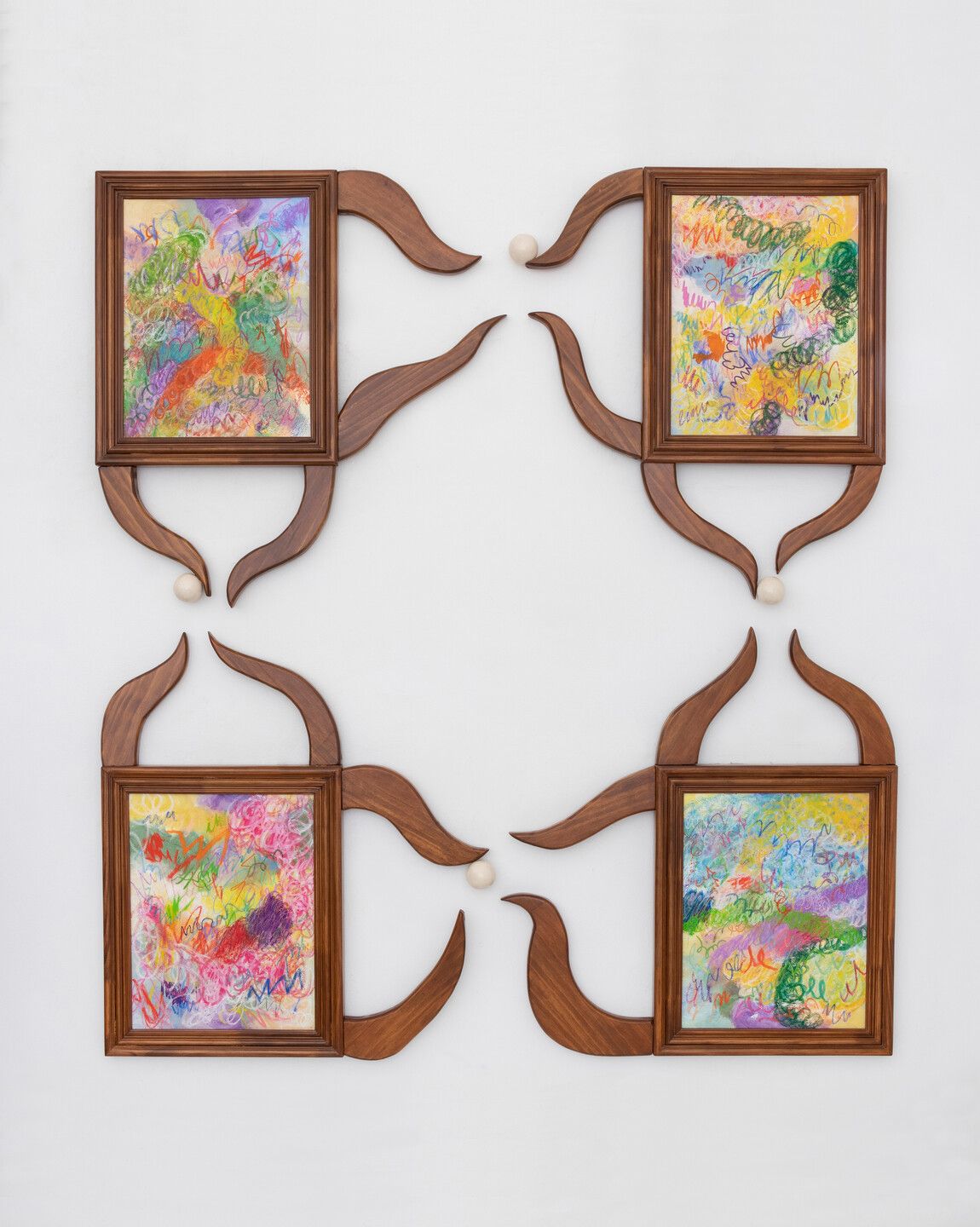 Two wall art pieces made of wood, pearl, beads, and canvas emanate an organic, rustic essence and lots of color.