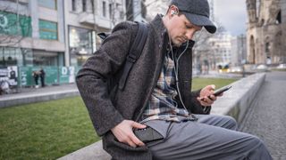 a man listening to music on his phone with the chord mojo 2 portable dac