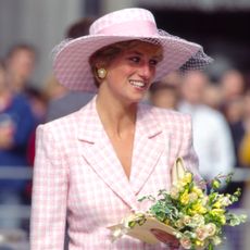 Princess Diana wearing a pink checked Armani suit and hat