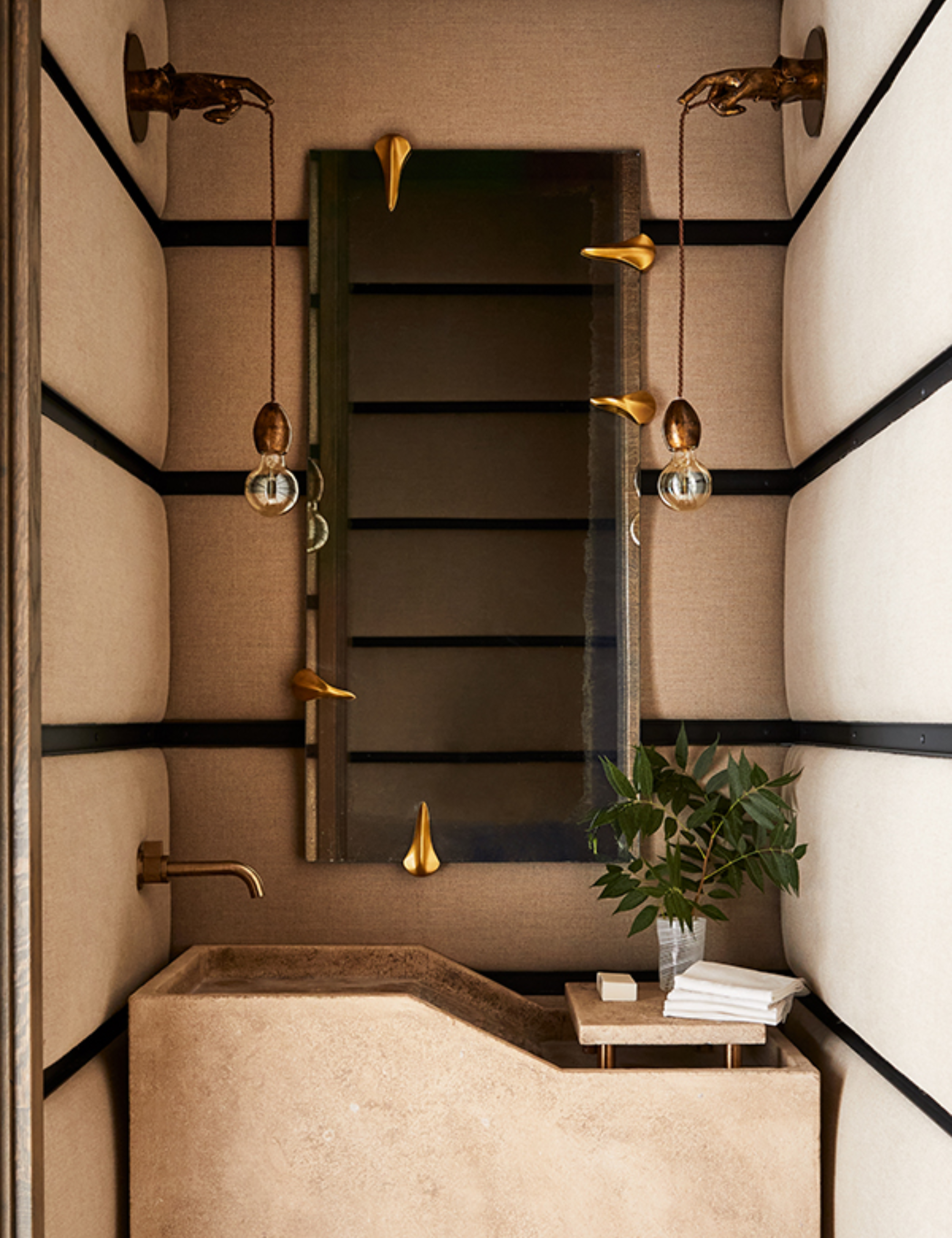 Neutral bathroom featuring a trough sink and brass, tack-room-inspired fixtures
