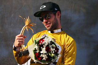 Mark Cavendish has a look at his new trophy