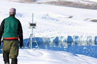 Canadian researcher Brad Danielson maintaining a time-lapse camera overlooking the Belcher Glacier, Devon Island, Nunavut, Canada. Monitoring the ice that breaks off from the glacier helps the researchers constrain how much ice is calving into the ocean.