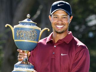 Tiger Woods wins the 2005 WGC AMEX and stands with the trophy