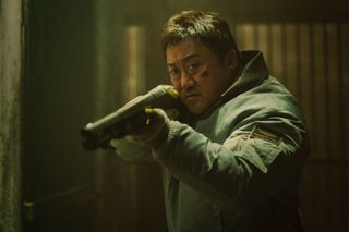 a man (don lee) aims a shotgun