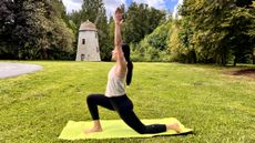 Woman in yoga pose on a mat in her garden