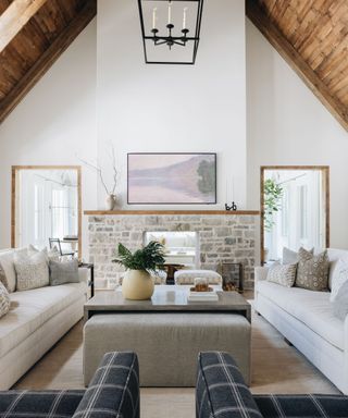 Living room with wooden clad walls and white sofa