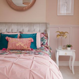 master bedroom with pink wall and white table