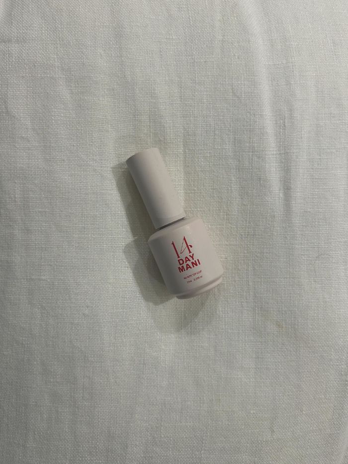 The 14 Day Mani Clear Hema-Free No-Wipe Top Coat on a white linen background