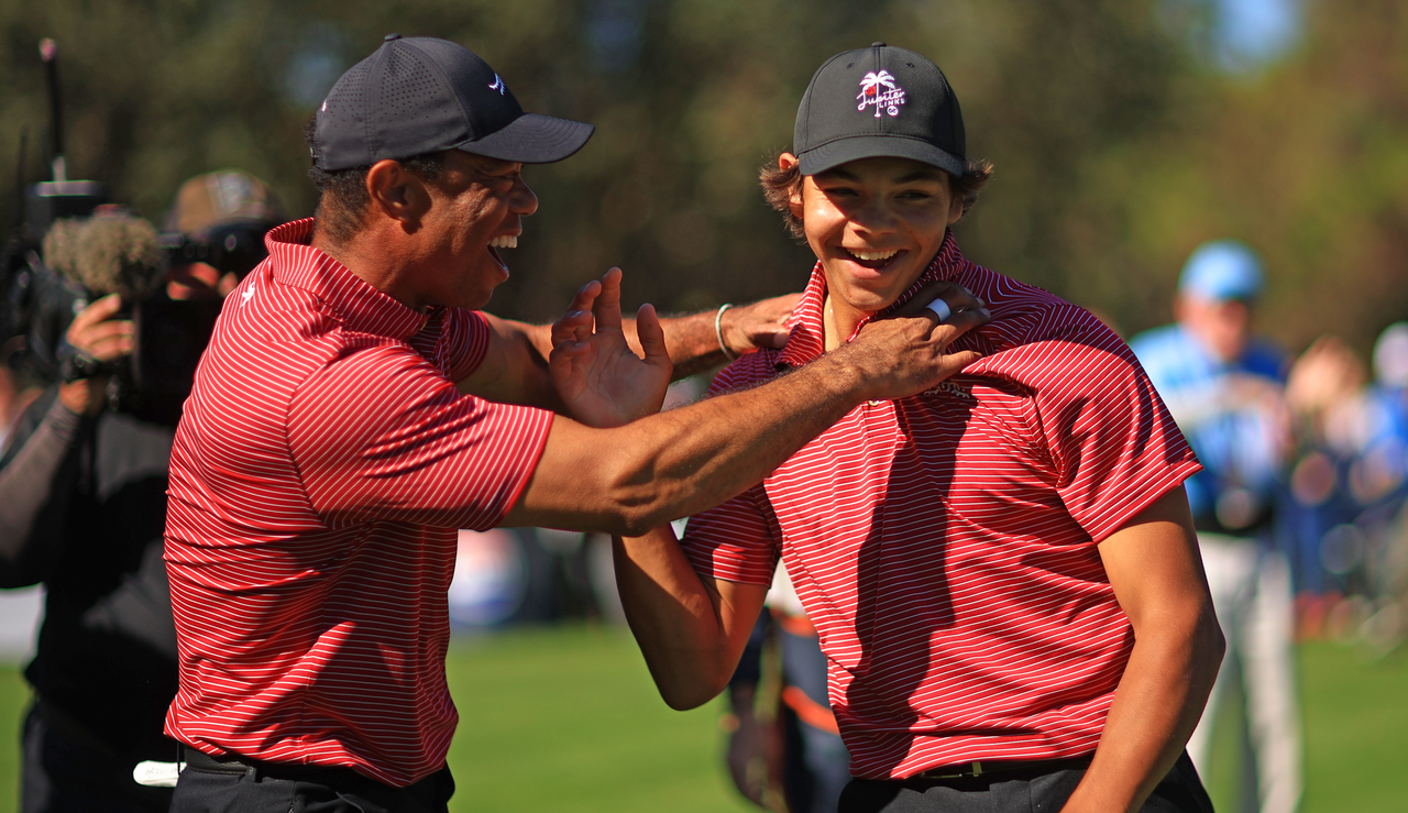 Tiger and Charlie Woods celebrate after Charlie&#039;s hole in one