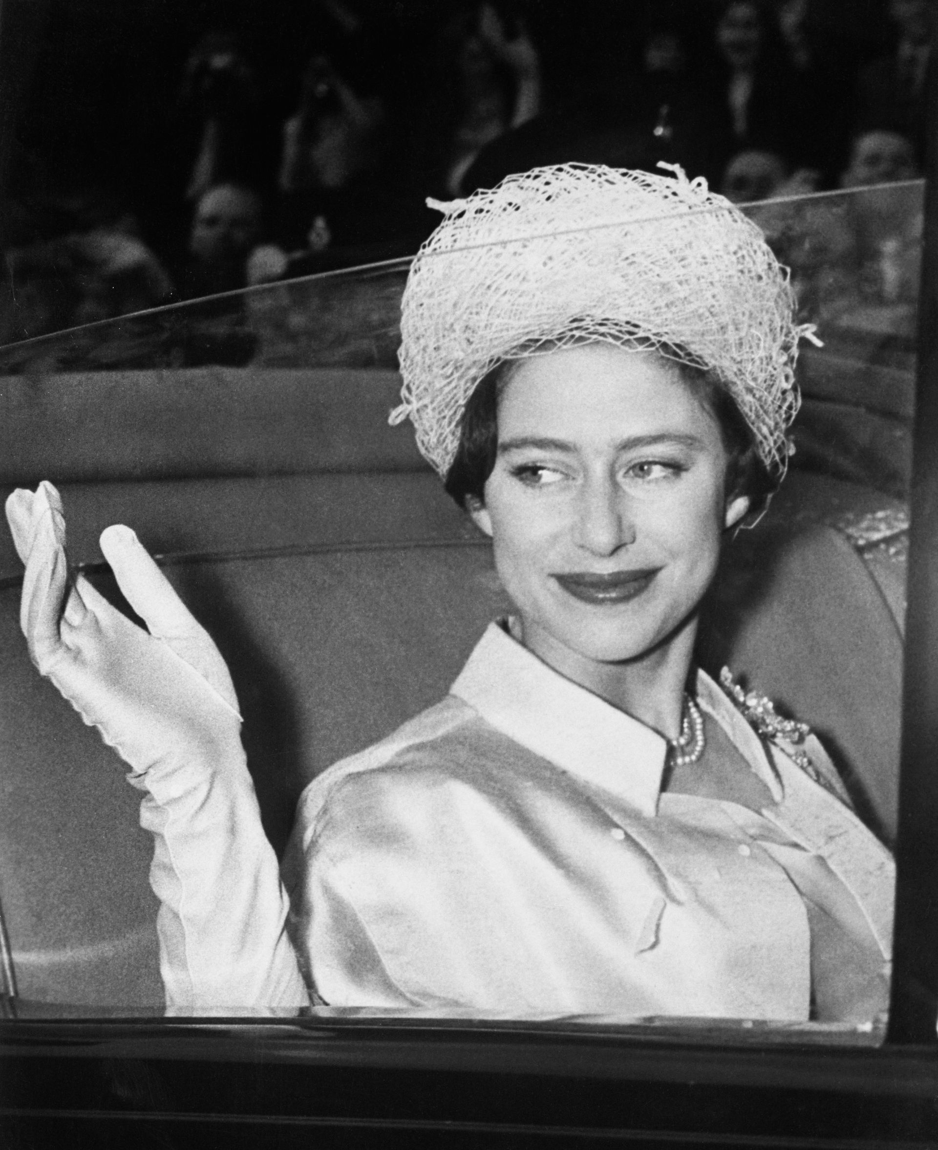 Princess Margaret waving from a car