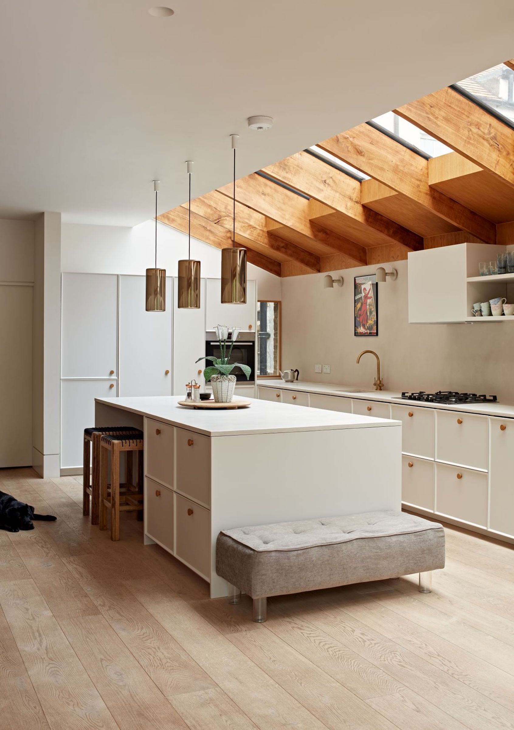 kitchen extension with white units and wood beams