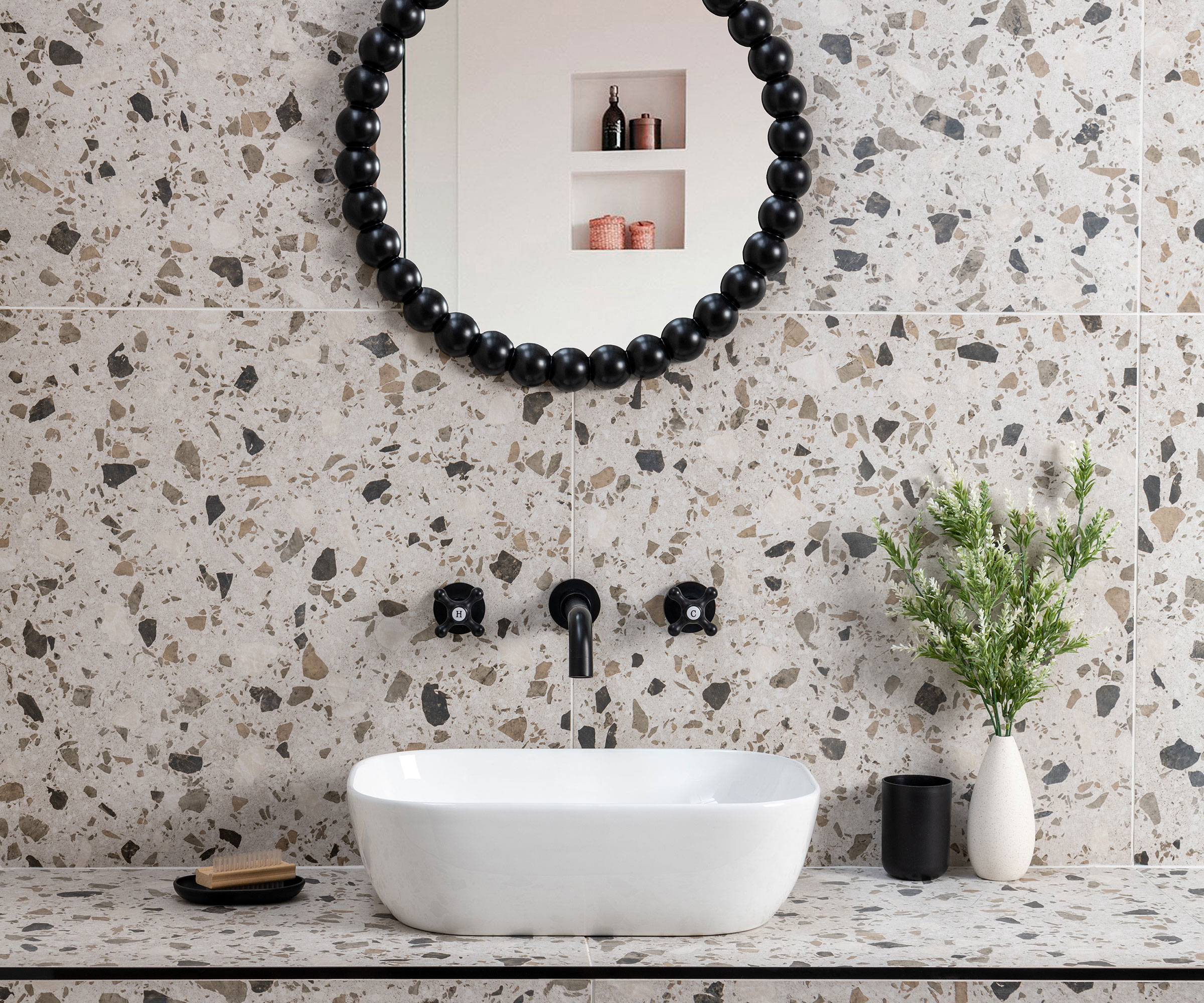 terrazzo effect porcelain walls tiles with countertop basin and wall mounted black taps