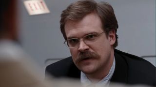 David Harbour speaking with a concerned expression on his face in Quantum of Solace.