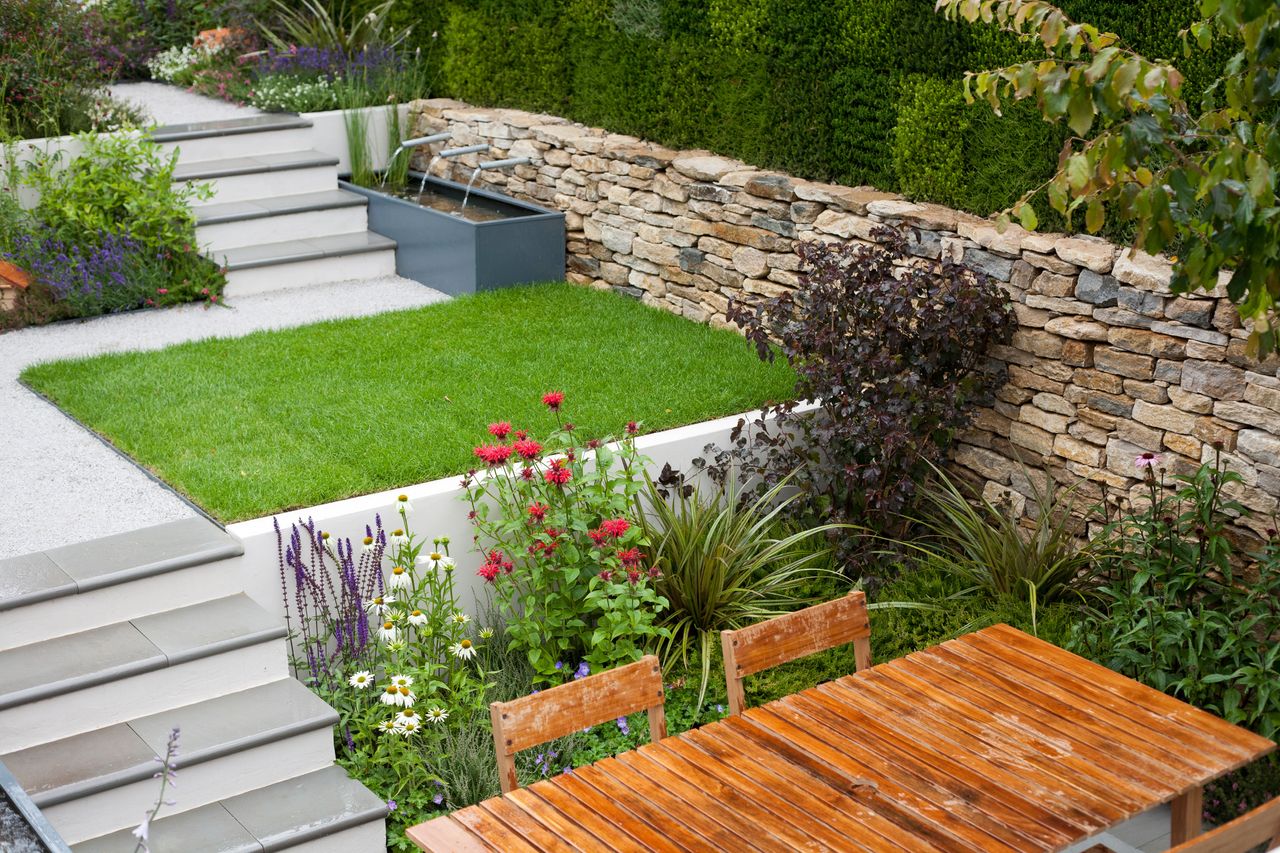 A modern sunken garden with a border of flowers