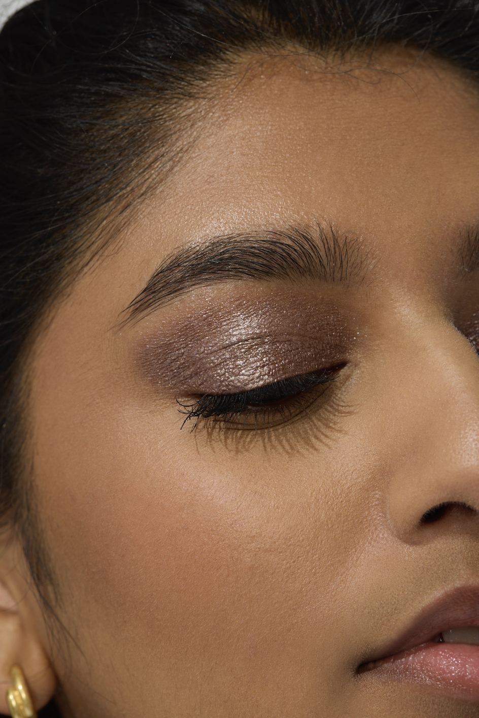 woman with metallic eyeshadow and thick black eyeliner