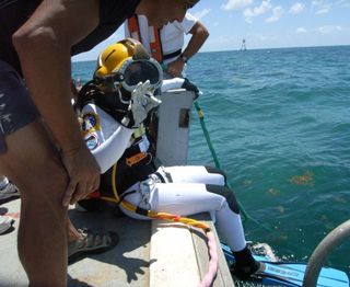 NASA astronaut Kate Rubins just before diving into the water en route to the Aquarius underwater laboratory. Rubins was on the SEATEST aquanaut crew that worked in the lab in September 2013.