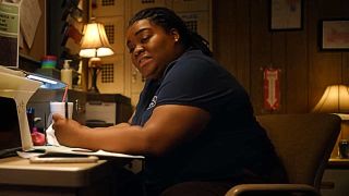 Shazz (Da'Vine Joy Randolph) doing paperwork in The Last Shift