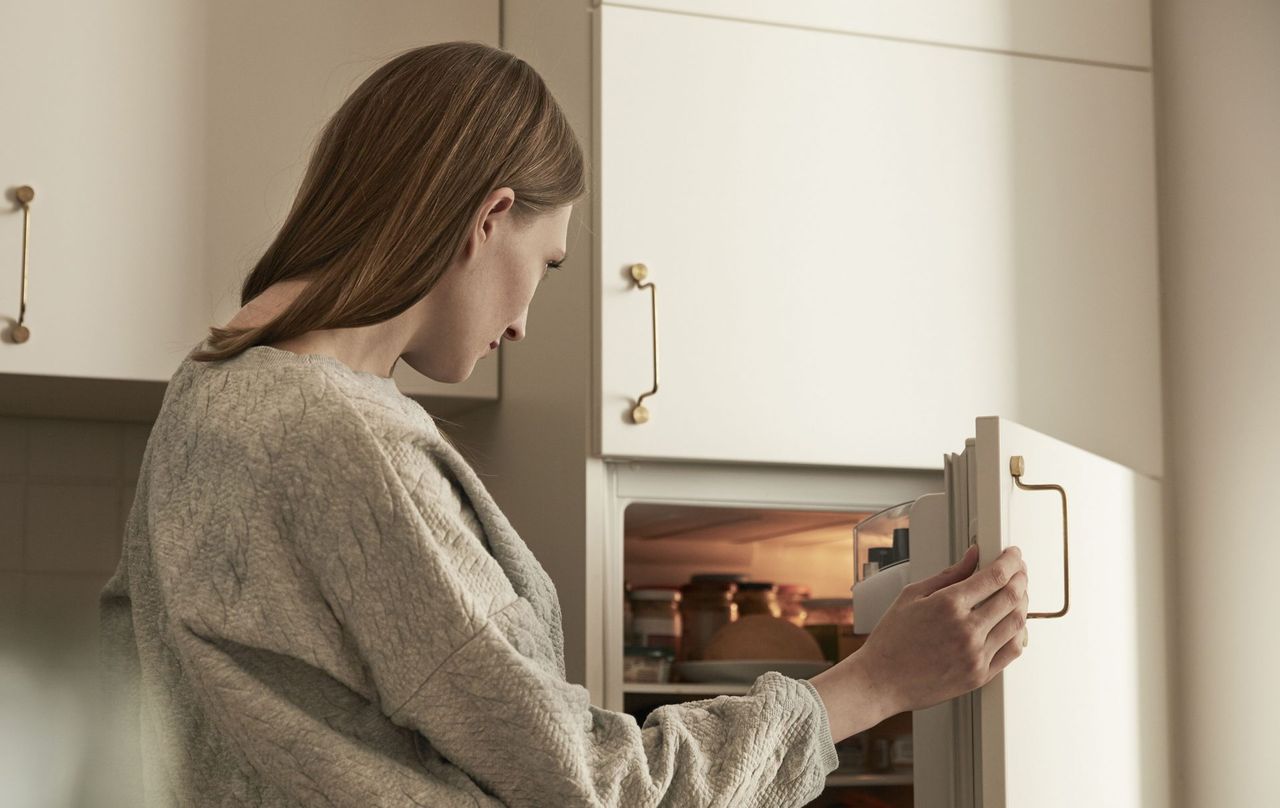 woman looking in fridge