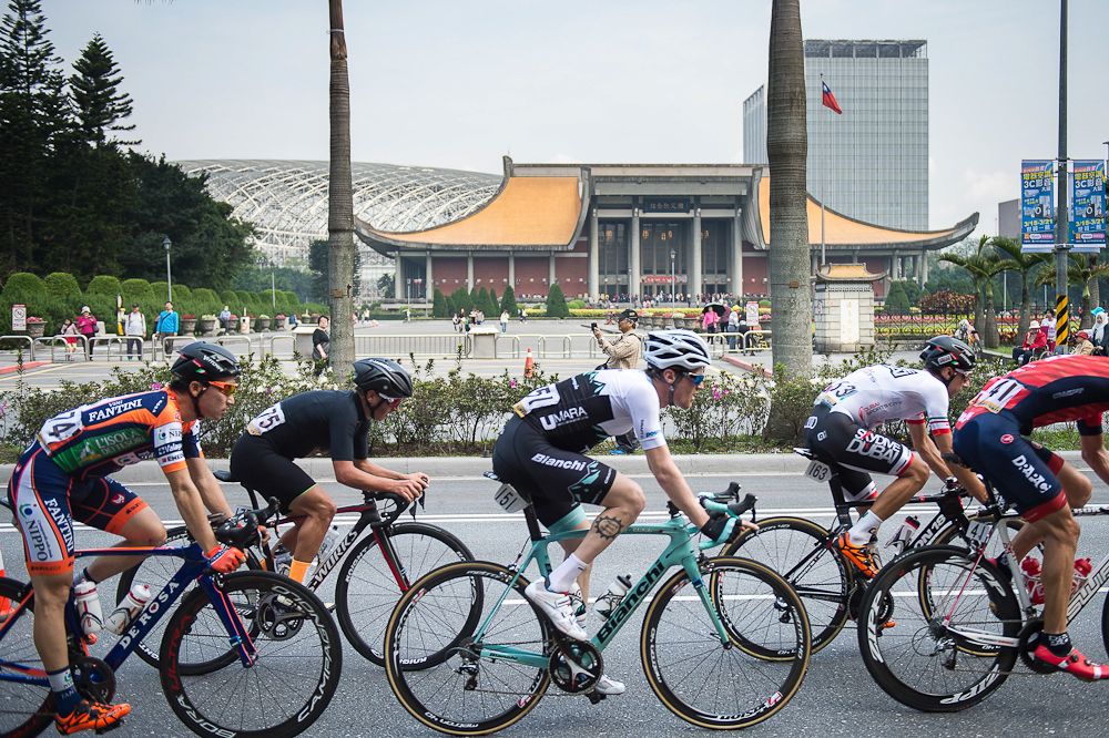The peloton passes a pagoda at the Tour de Taiwan.