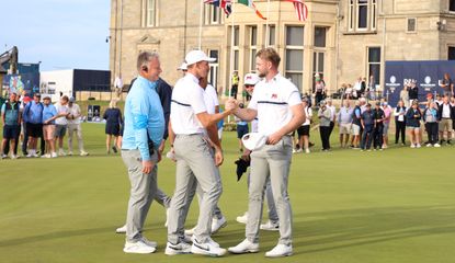 Team GB&I shake hands on the 18th green