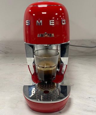 Making espresso with the Smeg Lavazza A Modo Mio in red colorway