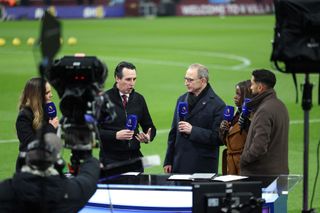 Aston Villa's Spanish head coach Unai Emery (2L) gives an interview to amazon Prime, pitch-side ahead of the English Premier League football match between Aston Villa and Manchester City at Villa Park in Birmingham, central England on December 6, 2023