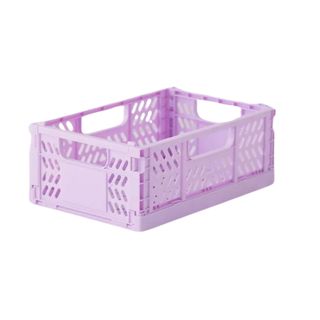 A small, bright lilac plastic crate with cutouts throughout