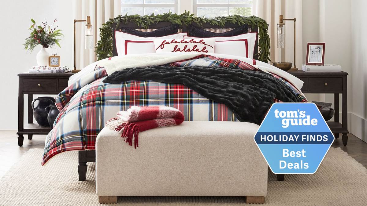 Image shows a red, white and green Christmas plaid bedding set covering a luxury mattress in a hotel-style bedriin