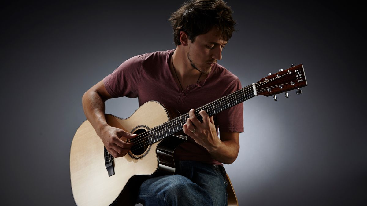 A man playing an acoustic guitar