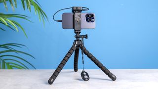 Amazon Basics tripod against a blue background