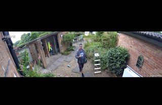 Image from a Reolink Argus 4 Pro security camera showing a man in his garden