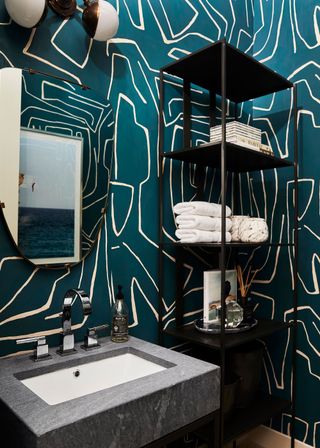 Modern powder room with wallpaper and metal fittings