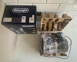 Unboxed De'Longhi Clessidra coffee maker with plastic packaging