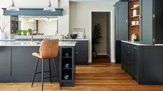 Dark blue kitchen with statement kitchen island seen as a feature that can help sell your house