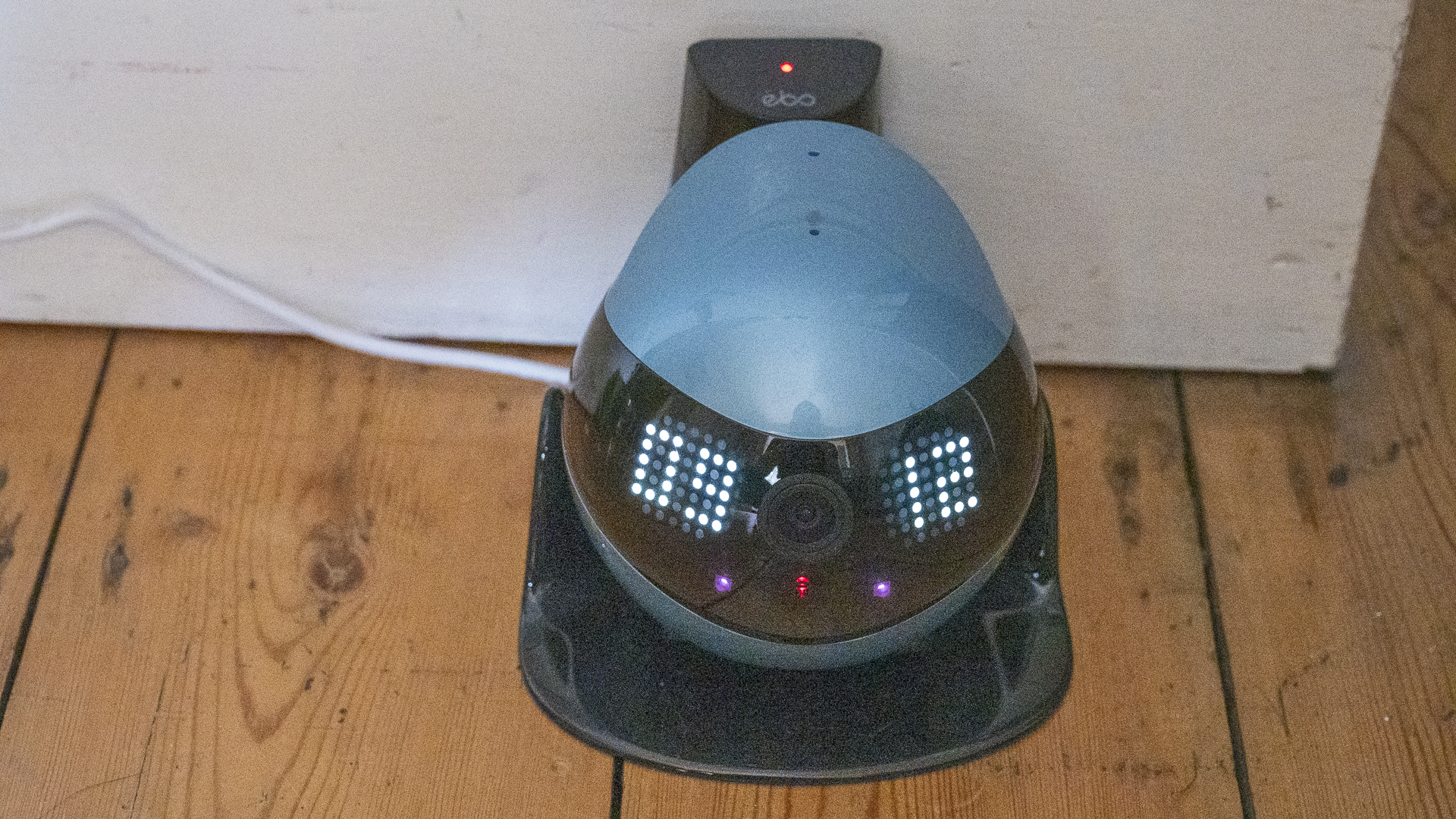 Enabot Ebo Air 2 on charging station displaying the time