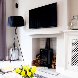 white wall living room with television and black side lap