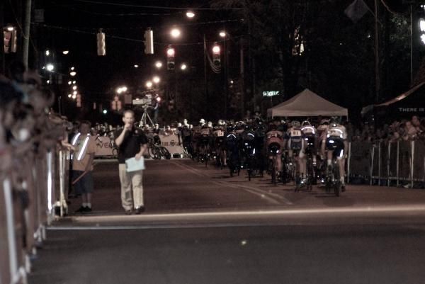The men's peloton heads into the first turn.