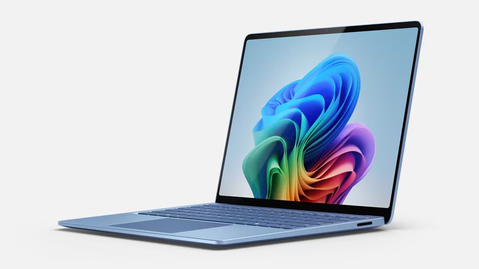 A blue microsoft surface laptop opened to its colorful display