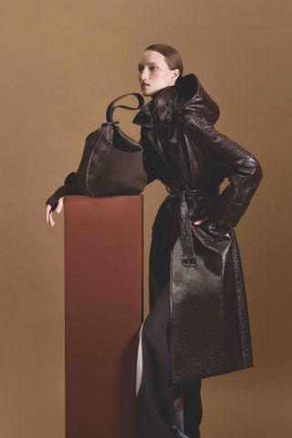 Model in Akris A/W 2024 holds Akris AI bag