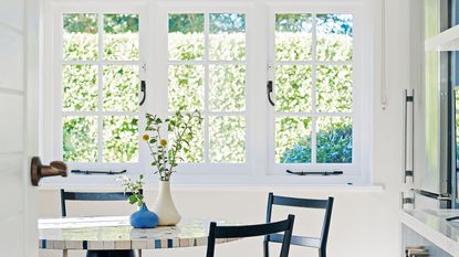 kitchen window with dining table and chairs