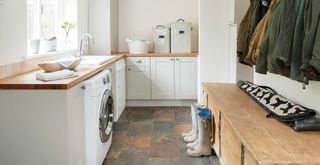 neutral utility and boot room with washing machine and sink