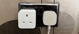 The Philips Hue smart plug connected to a power outlet