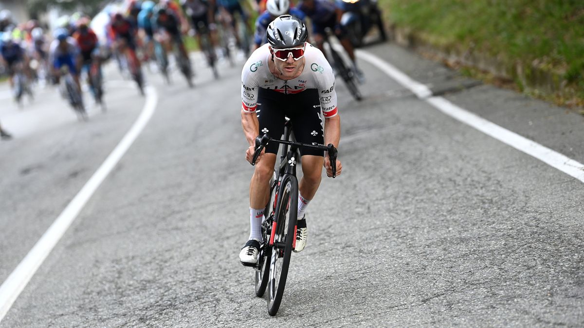 Marc Hirschi, in white and black cycling gear, makes a solo attack at the Gran Piemonte.