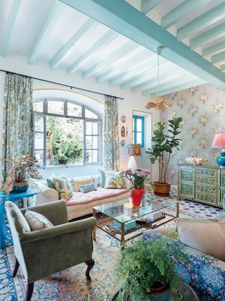living room with mediterranean colors of blue and floral wallpaper
