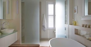 White bathroom with shower with glass screen