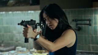 Jane (Maya Erskine) holding a machine pistol in Mr. & Mrs. Smith episode 8